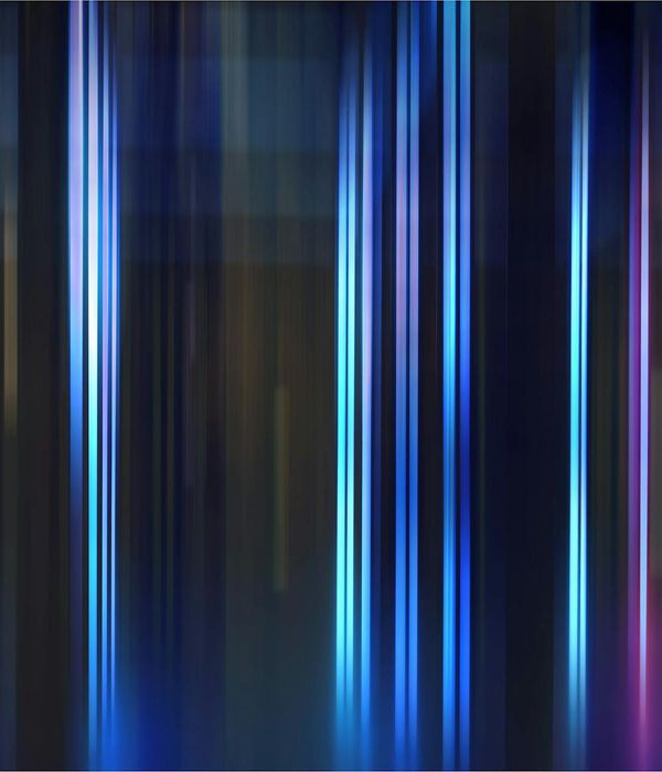 Person stretching energetically against a dark background with blue light streaks.